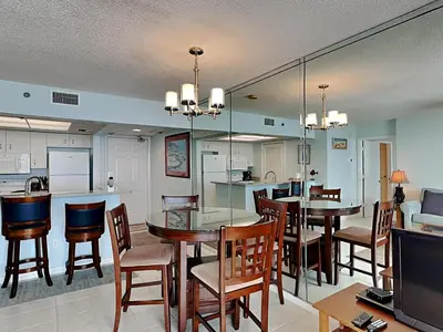a kitchen and dining room with a table and chairs at Long Beach Resort Tower III #602 in Panama City Beach