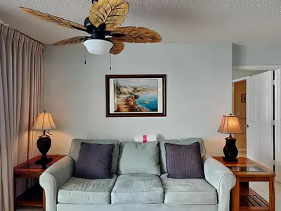 a living room with a couch and a ceiling fan at Long Beach Resort Tower III #602 in Panama City Beach