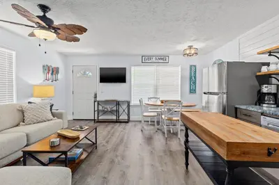 a living room with a couch and a table at Little Palm Unit A in Panama City Beach