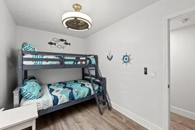 a bedroom with bunk beds in a room at Little Palm Unit A in Panama City Beach