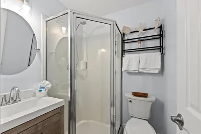 a bathroom with a shower and a toilet and a sink at Little Palm Unit A in Panama City Beach