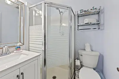 a bathroom with a shower and a toilet and a sink at Top Shelf 47 Unit C in Panama City Beach
