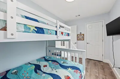 a white bunk bed in a white room with a bunk beduteneway at Top Shelf 47 Unit C in Panama City Beach