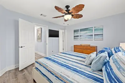 a bedroom with a bed and a ceiling fan at Top Shelf 47 Unit C in Panama City Beach