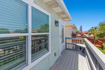 a balcony with blinds on a house at Top Shelf 47 Unit C in Panama City Beach