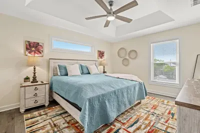 a bedroom with a bed and a ceiling fan at Heated Pool & Pet Friendly - Minutes To Beach - Spacious Backyard - FLPCB38 in Panama City Beach