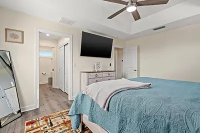 a bedroom with a bed and a flat screen tv at Heated Pool & Pet Friendly - Minutes To Beach - Spacious Backyard - FLPCB38 in Panama City Beach