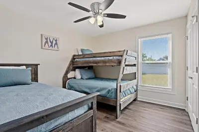 a bedroom with a bunk bed and a ceiling fan at Heated Pool & Pet Friendly - Minutes To Beach - Spacious Backyard - FLPCB38 in Panama City Beach