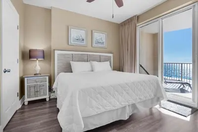a bedroom with a bed and a balcony at Ocean Villa 803 in Panama City Beach