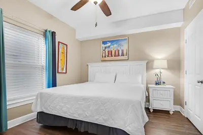 a bedroom with a white bed and a window at Ocean Villa 803 in Panama City Beach