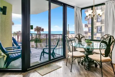 a dining room with a view of the ocean at Sunbird 211E in Panama City Beach