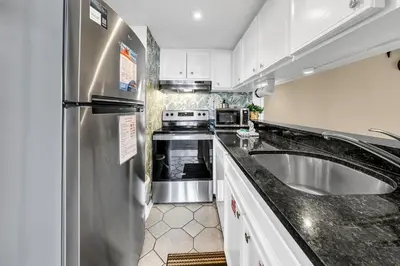 a kitchen with a stainless steel refrigerator and a sink at Sunbird 211E in Panama City Beach