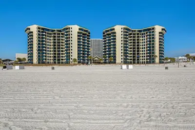 two tall buildings in the background of a beach at Sunbird 211E in Panama City Beach