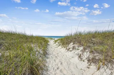a path through the sand on a beach at Splash Pad by Book That Condo in Panama City Beach