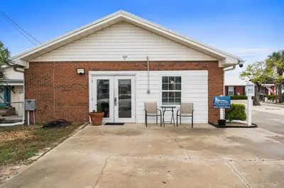 a house with a table and chairs in front of it at Splash Pad by Book That Condo in Panama City Beach