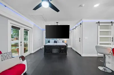 a living room with a couch and a flat screen tv at Splash Pad by Book That Condo in Panama City Beach