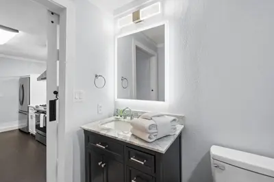 a bathroom with a sink and a mirror at Splash Pad by Book That Condo in Panama City Beach