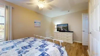 a bedroom with a bed and a tv on a dresser at Near Pier Park and Beach - Pools Onsite - FLPCB66 in Panama City Beach