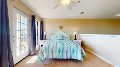 a bedroom with a bed with a striped bedspread at Near Pier Park and Beach - Pools Onsite - FLPCB66 in Panama City Beach