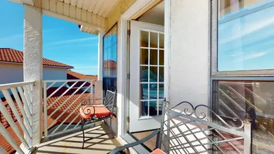 a balcony with a bench and a door at Near Pier Park and Beach - Pools Onsite - FLPCB66 in Panama City Beach