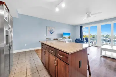 a kitchen with a refrigerator and a counter top at Laketown Wharf 116 in Panama City Beach