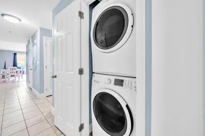 a laundry room with two washer and dryer at Laketown Wharf 116 in Panama City Beach