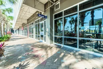 a building with palm trees in front of it at Laketown Wharf 116 in Panama City Beach