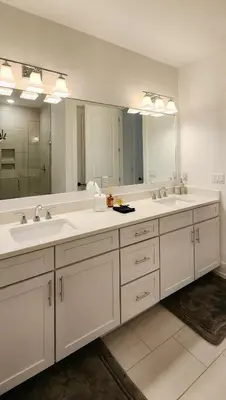 a bathroom with two sinks and a large mirror at Flounder by the Sea in Panama City Beach