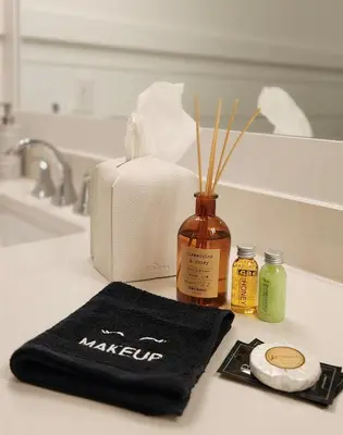 a bathroom counter with a towel and a bottle of makeup at Flounder by the Sea in Panama City Beach
