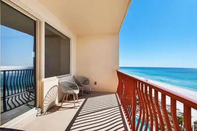 a balcony with chairs and a view of the ocean at Hidden Dunes 901 in Panama City Beach