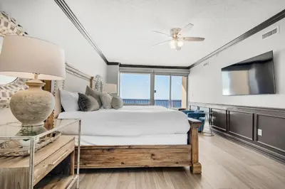 a bedroom with a bed and a ceiling fan at Hidden Dunes 901 in Panama City Beach