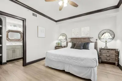 a white bedroom with a bed and a ceiling fan at Hidden Dunes 901 in Panama City Beach