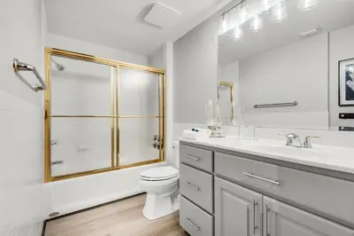 a bathroom with a shower and a toilet and a sink at Hidden Dunes 901 in Panama City Beach