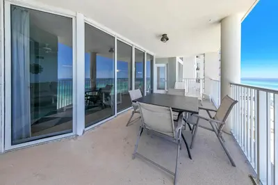 a balcony with a black table and chairs on it at Long Beach Resort 1-1203 in Panama City Beach