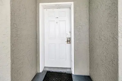 a white door in a room with a black floor at Long Beach Resort 1-1203 in Panama City Beach