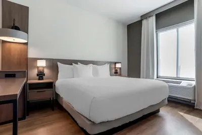 a bedroom with a large white bed and a window at Comfort Inn & Suites Panama City Beach - Pier Park Area in Panama City Beach