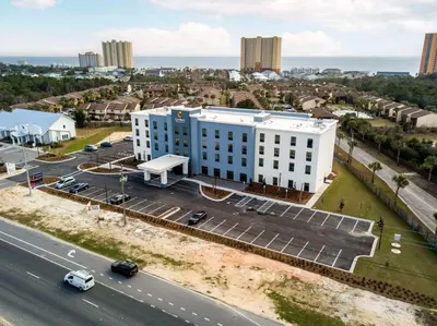 an aerial view of a white building next to a road at Comfort Inn & Suites Panama City Beach - Pier Park Area in Panama City Beach