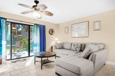 a living room with a couch and a ceiling fan at Gulf Highlands 220 in Panama City Beach