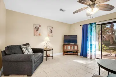a living room with a couch and a tv at Gulf Highlands 220 in Panama City Beach