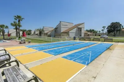 a swimming pool with yellow and blue mats on it at Keep Palm and Carry On - 5 min walk to beach in Panama City Beach