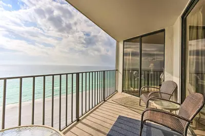 a balcony with chairs and a view of the ocean at Idyllic PCB Condo with Pool Access and Ocean Views! in Panama City Beach