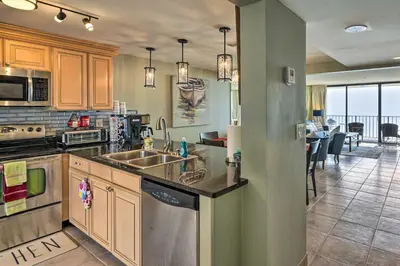 a kitchen with a sink and a stove top oven at Idyllic PCB Condo with Pool Access and Ocean Views! in Panama City Beach