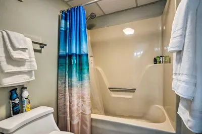 a bathroom with a shower curtain and a toilet at Idyllic PCB Condo with Pool Access and Ocean Views! in Panama City Beach