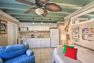 a kitchen with a couch and a ceiling fan at Steps to Sand, Pool Access Cozy Panama City Condo in Panama City Beach