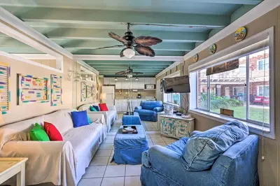 a living room with couches and a ceiling fan at Steps to Sand, Pool Access Cozy Panama City Condo in Panama City Beach