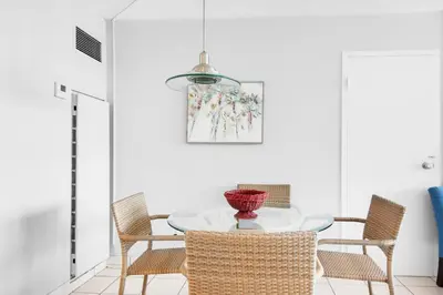 a dining room with a table and chairs at Top of the Gulf 208 in Panama City Beach