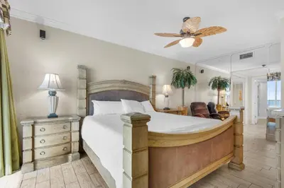 a bedroom with a large bed and a ceiling fan at Majestic Beach Towers 2-1305 in Panama City Beach