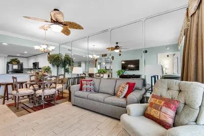 a living room with a couch and a dining room at Majestic Beach Towers 2-1305 in Panama City Beach