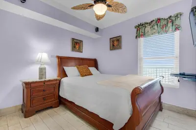 a bedroom with a bed and a ceiling fan at Majestic Beach Towers 2-1305 in Panama City Beach