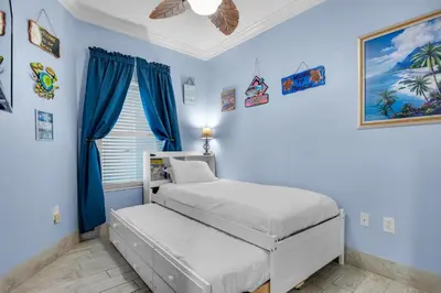 a bedroom with two beds and blue walls at Majestic Beach Towers 2-1305 in Panama City Beach